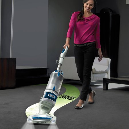A woman vacuuming with a shark vacuum cleaner